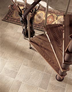 freshly installed luxury vinyl tile with a spiral staircase above it 